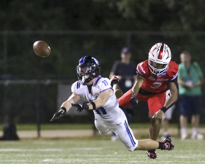 St. Francis's Tanner Glock (11) has a pass reception broken up during football game between St. Francis at Kenwood Academy on Thursday, Aug 28, 2025  in Chicago.