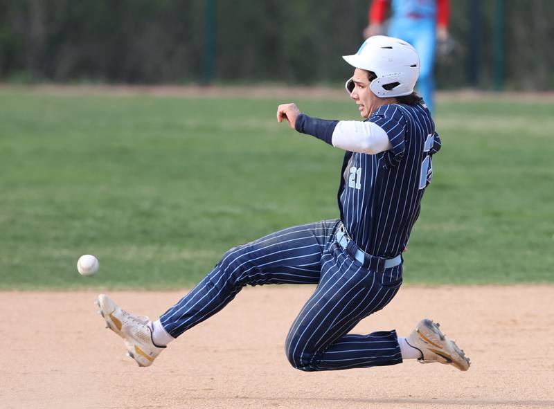 Nazareth's Jaden Fauske (21) tries to outrun the throw to second base during the varsity baseball game between Benet Academy and Nazareth Academy in La Grange Park on Monday, April 24, 2023.