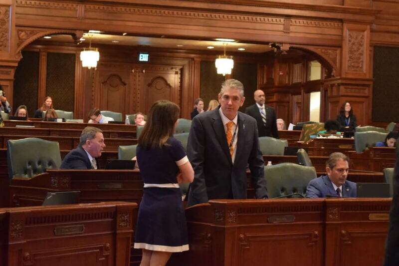 Rep. Dave Vella, D-Rockford, speaks with a colleague in the Illinois House on Wednesday, April 9, 2025