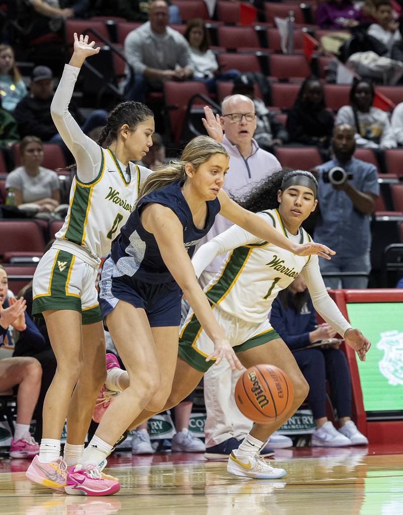 Nazareth Academy’s Stella Sakalas wrks against Waubonsie Valley’s Maya Pereda (left) and Arianna Garcia Friday, March 1, 2024 in the girls basketball 4A state semifinal at CEFCU Arena in Normal.