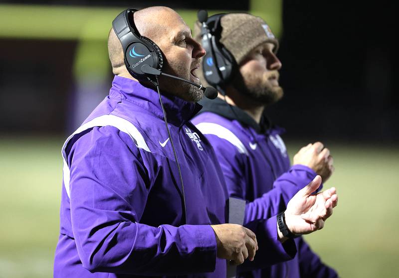 Dixon head coach Jared Shaner calls in a play during their first round playoff game against Rochelle Friday, Oct. 28, 2022, at Rochelle High School.