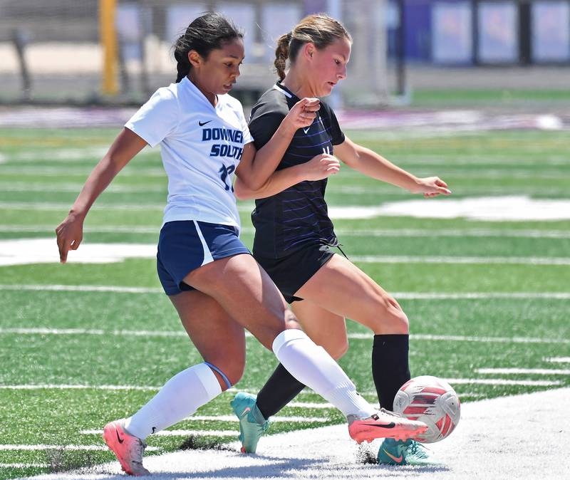 Downers Grove South’s Isa Okuku (left) and Downers Grove North’s Gabriella Menzione tangle for the ball during a game on May 10, 2025 at Downers Grove North High School in Downers Grove .