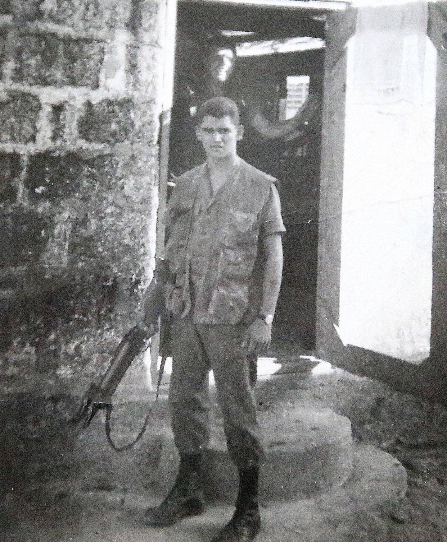 United States Marine Veteran Gordon Parks poses for a photo holding a grenade launcher near the Trout River Bridge in 1966. Parks was a Marine Veteran who fought in the VIetnam War.