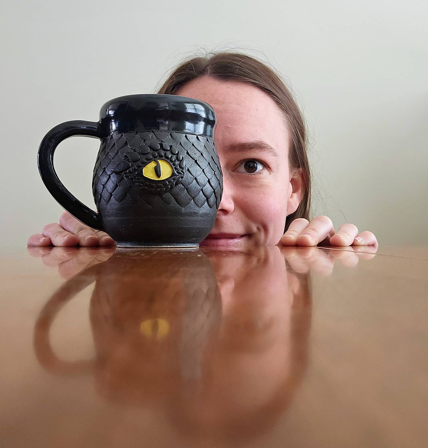 Artist Liza Mitchem loves experimenting with how light plays with the iridescence of dragon scales on her mugs.
