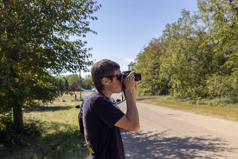Riley Keith of Genoa takes a picture of the demolition of  the coal tower Tuesday, Sept. 16, 2025. Keith has made several trips to Nelson to photograph the last train that traveled under the tower and to bear witness to a vanishing piece of railroad history.