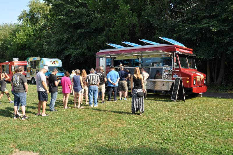 People line up at a food truck at a Forest Preserve District of Will County's Food Truck Friday in 2018 in Hammel Woods in Shorewood. Food truck events are a great way to introduce the community to the amenities the forest preserve offers.