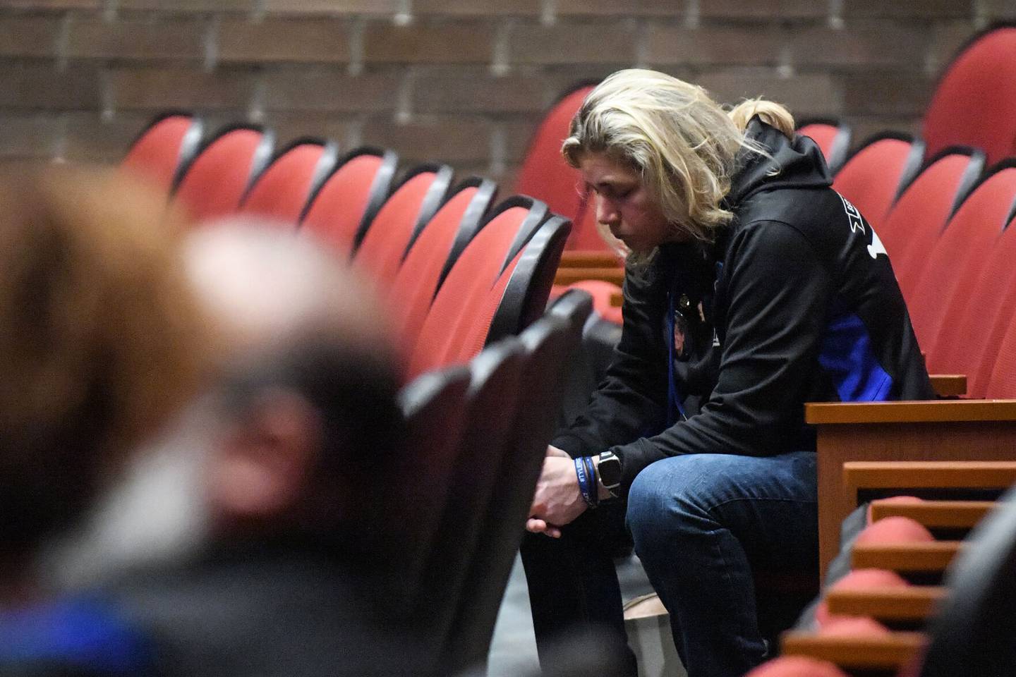 Lyn Stua-Rittmanic listens to stories about her wife, fallen Bradley Sgt. Marlene Rittmanic, during a Memorial Service held Friday, Dec. 29, 2022, on the one-year anniversary of her death.