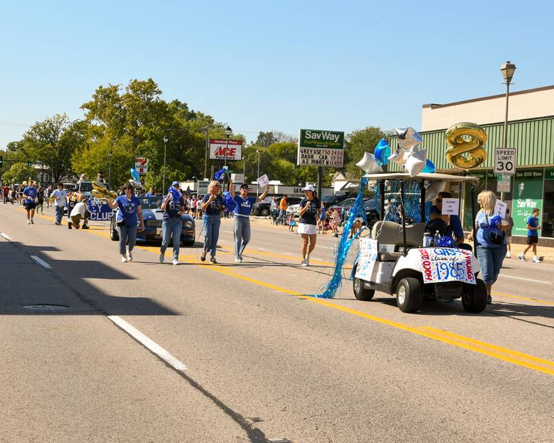 Members of the Geneva High School Class of 1985 walk in the 2025 Homecoming Parade on Friday, Sept. 26, 2025, along State Street in downtown Geneva.