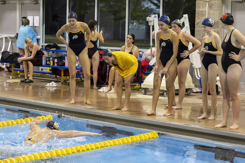 Teammates cheer on Aven Habben in the 200 IM race against Rock Island Tuesday, Sept. 30, 2025.