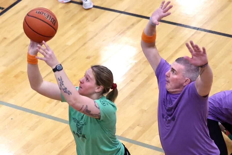 Fire/Police team member Keeley Meyer shoots in front of Sycamore School Staff team member Jeff Hilmer Thursday, Dec. 19, 2024, during the Heroes on Hardwood basketball game at Sycamore High School. The basketball game, which is a fundraiser for the Spartan Food Pantry, pits a team of Sycamore first responders against a squad of Sycamore School District 427 staff.