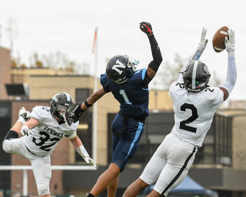 Nazareth Academy's Trenton Walker (1) goes up for a pass while Fenwick's Josh Morgan (2) catches the ball for the interception during the 6A semifinals game on Saturday Nov. 22, 2025, held at Nazareth Academy High School in La Grange Park.