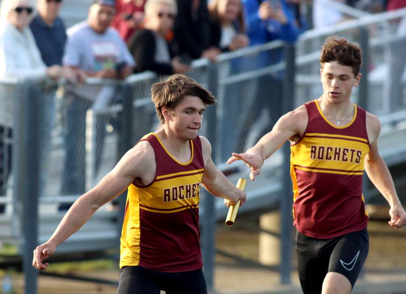 Richmond-Burton’s Max Loveall, right, hands off to Daniel Kalinowski in the 800-meter relay during Kishwaukee River Conference track meet action at Marengo Tuesday night.