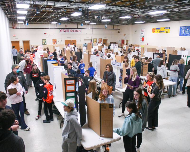 Students in Downers Grove stand next to their science projects as judges make their rounds on Saturday Jan. 25, 2025, during the Downers Grove District  58 science fair held at O’Neill Middle school.