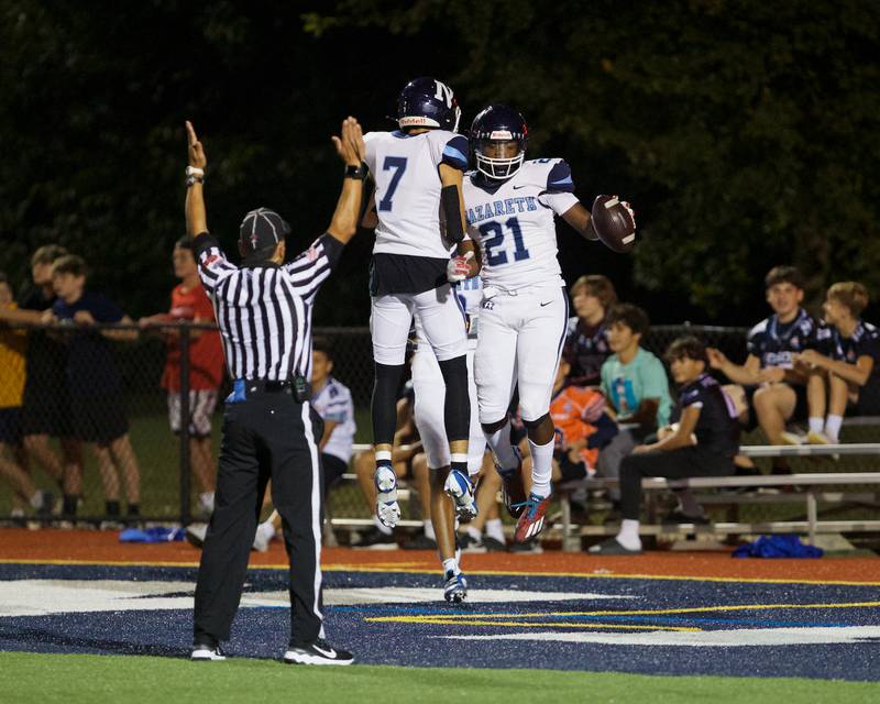 Nazareth's Jake Cestone (7) and Lesroy Tittle (21) celebrate a touchdown against IC Catholic on Friday, Sept.15,2023 in Elmhurst.