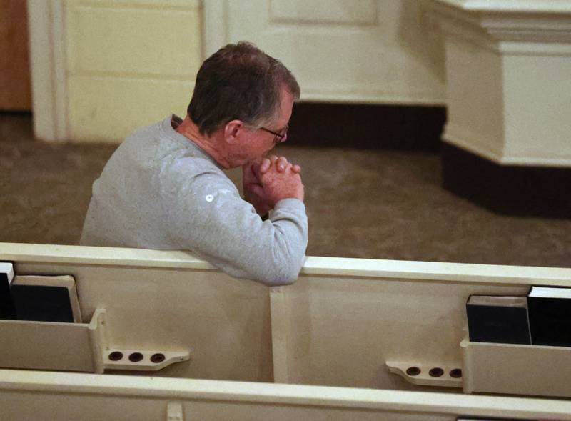 Pastor John Dorhauer prays Monday, Feb. 2, 2026, during the Vigil for Peace at the First Congregational United Church Of Christ in DeKalb. The vigil is being held in remembrance of those lost in recent ICE related shootings and to show solidarity with the people of Minnesota.