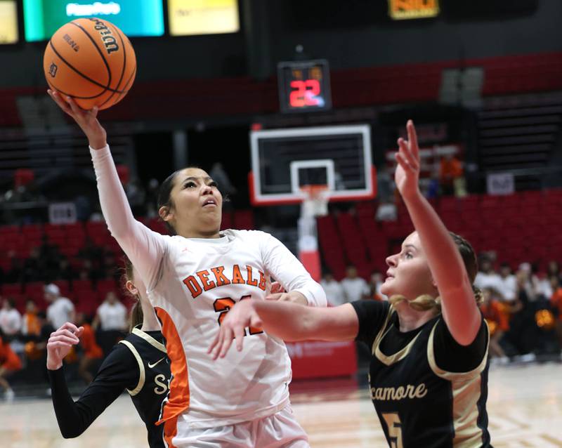 DeKalb's Alicia Johnson goes between Sycamore's Grace Amptmann Friday, Jan. 30, 2026, during their game in the FNBO Challenge in the Convocation Center at Northern Illinois University in DeKalb.
