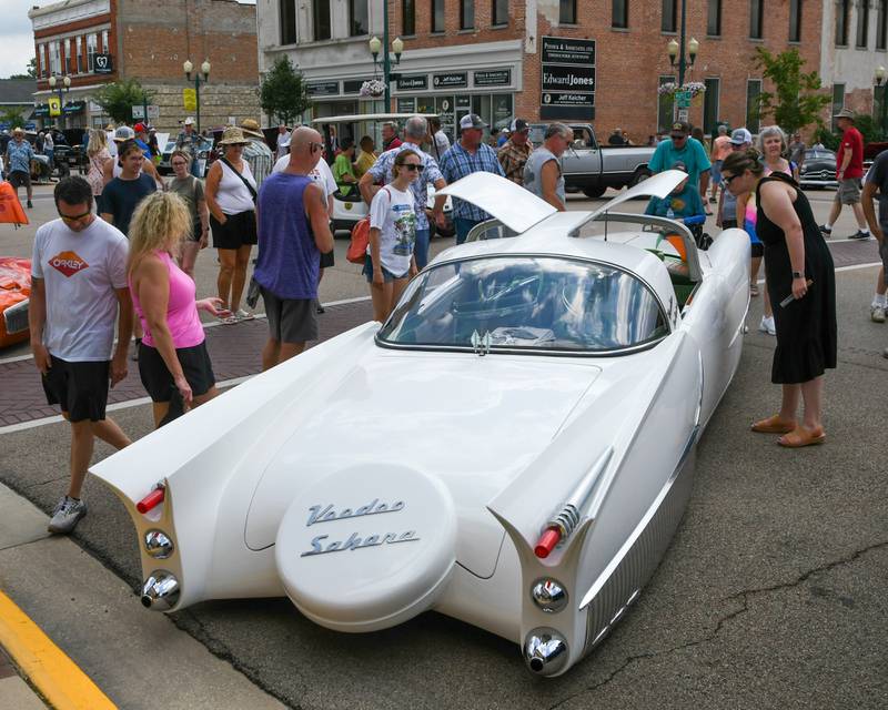 Many car enthusiast stop and look at the 1954 Kaiser Manhatten during the Turning back time car show on Sunday July 27, 2025, in downtown Sycamore.