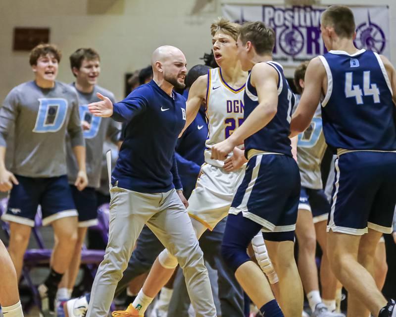 Downers Grove South's head coach Zach Miller greets the team after a fast start during basketball game between Downers Grove South at Downers Grove North. Dec 16, 2023.