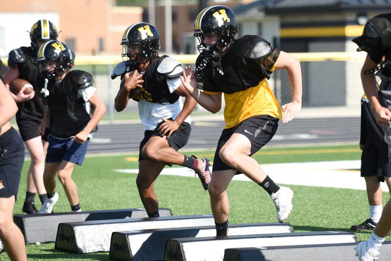 Herscher's Alek Draper, left, and Reed Laird work through a footwork drill at football practice Wednesday, Aug. 13, 2025.