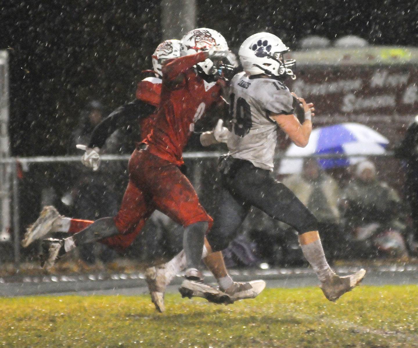 Streator's Aneefy Ford (9) runs down Wilmington's Colin James (19) after a 38-yard run as heavy rain falls at Doug Dieken Stadium on Friday, Oct. 14, 2022, in Streator.