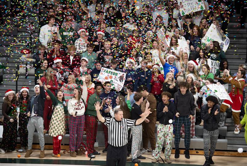Bishop McNamara students pop off confetti poppers after their team reached 10 points against Chicago Bulls Prep in a game on Friday, December 19, 2025.