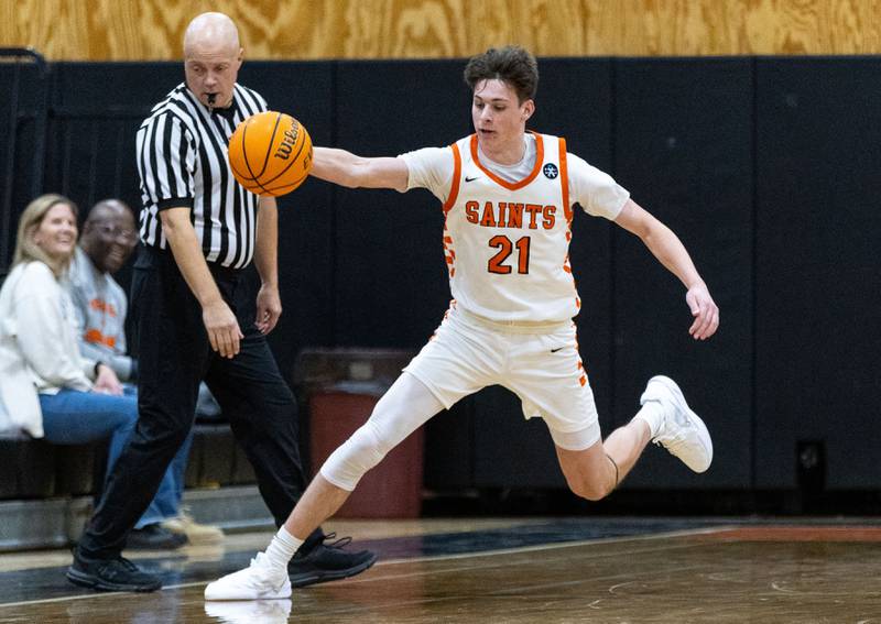St. Charles East guard Marco Klebosits keeps the ball in bounds during a game against Marmion Academy on Saturday, Jan. 4, 2025.