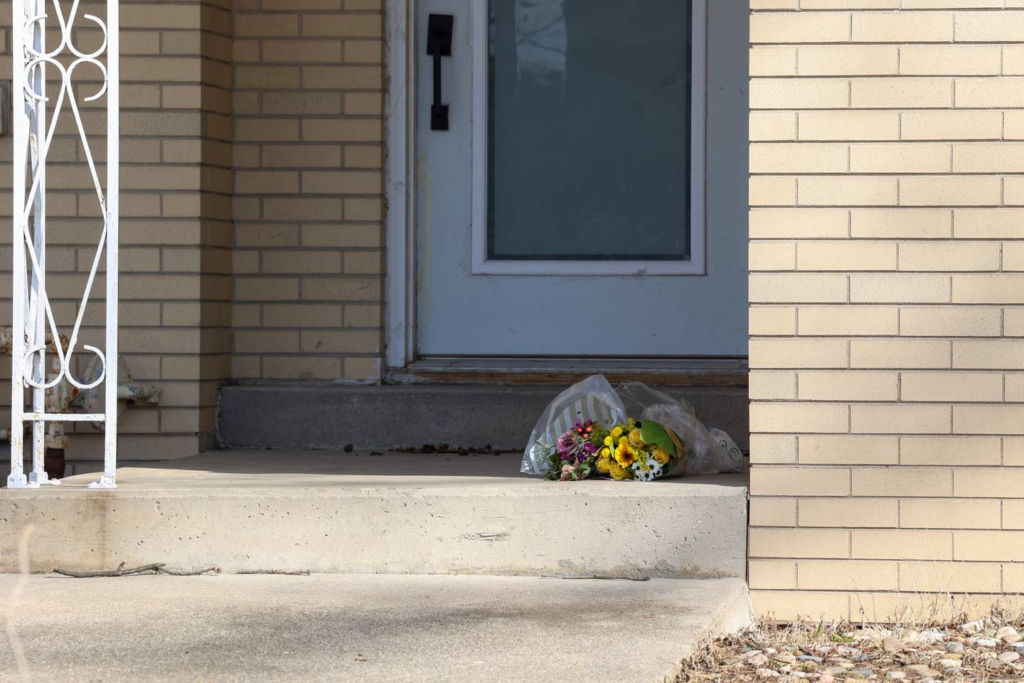 Flowers are placed on the doorstep to Maurice Norington's home in Aroma Township on Thursday, March 19, 2026.