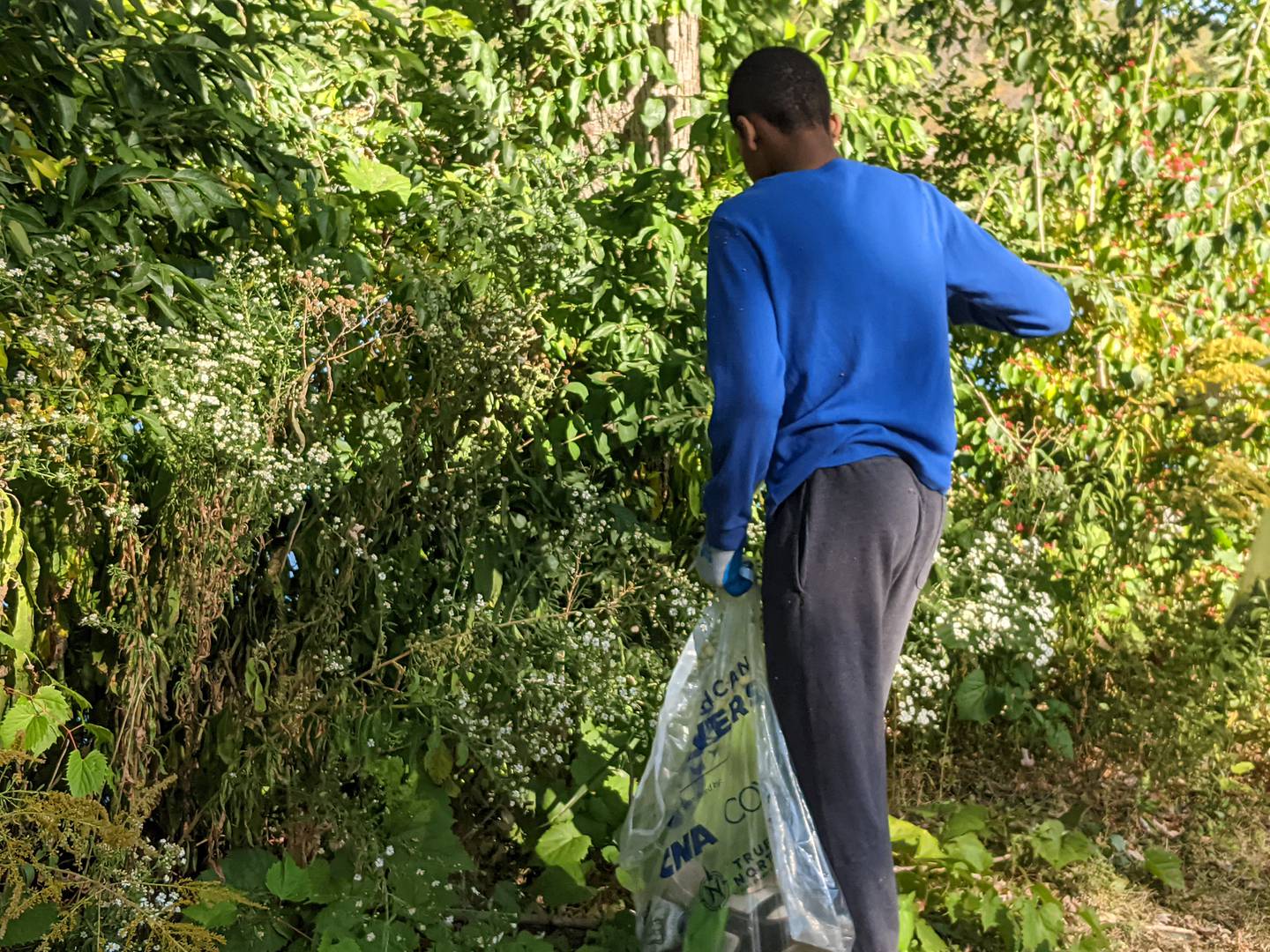 Oswego High School freshman Shawn Ifediora and others were picking up trash on Sept. 21 in the Oswegoland Park District’s Veterans Serenity Park along the Fox River as part of It’s Our Fox River Day. The annual event is coordinated by Friends of the Fox River.