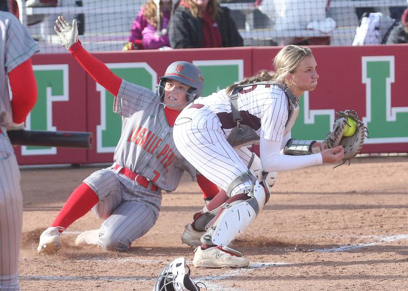 L-P's Callie Mertes slides in safely to home as the throw comes in late to Morris catcher McKenna Gliwa on Monday, April 7, 2025 at the L-P Athletic Complex in La Salle.