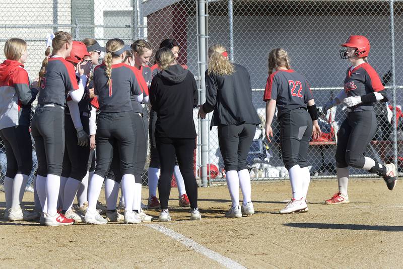 Maura Condon's teammates wait at home plate to congratulate her after her first-inning home run Thursday, March 21, 2024, in Streator.