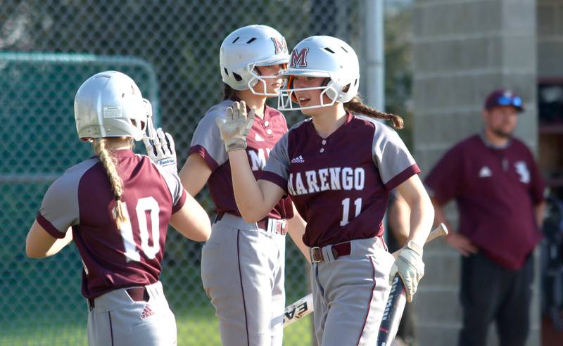 Marengo’s Jozsa Christiansen, center, celebrates with teammates as the Indians rally early against Richmond-Burton in varsity softball at Richmond Thursday night.