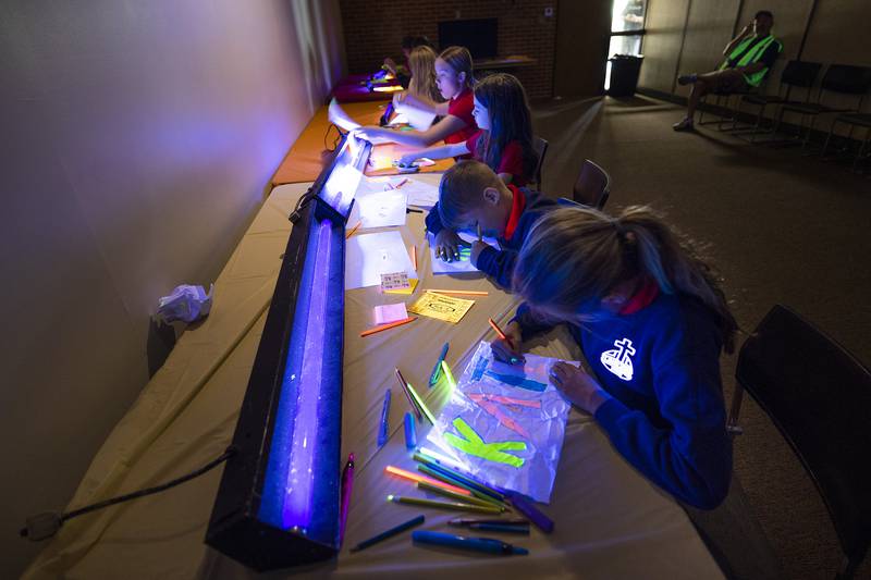 Working under a black light, St. Mary’s students create glowing works of art Friday, May 9, 2025, in Dixon.