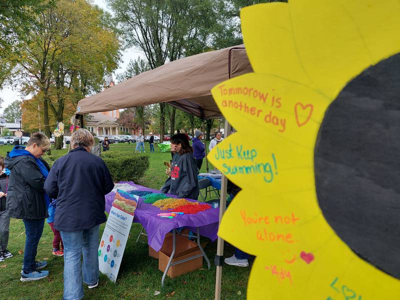 Hopeful message are written on sunflower art Saturday, Oct. 14, 2023, during the Out of the Darkness Walk at Washington Square in Ottawa.