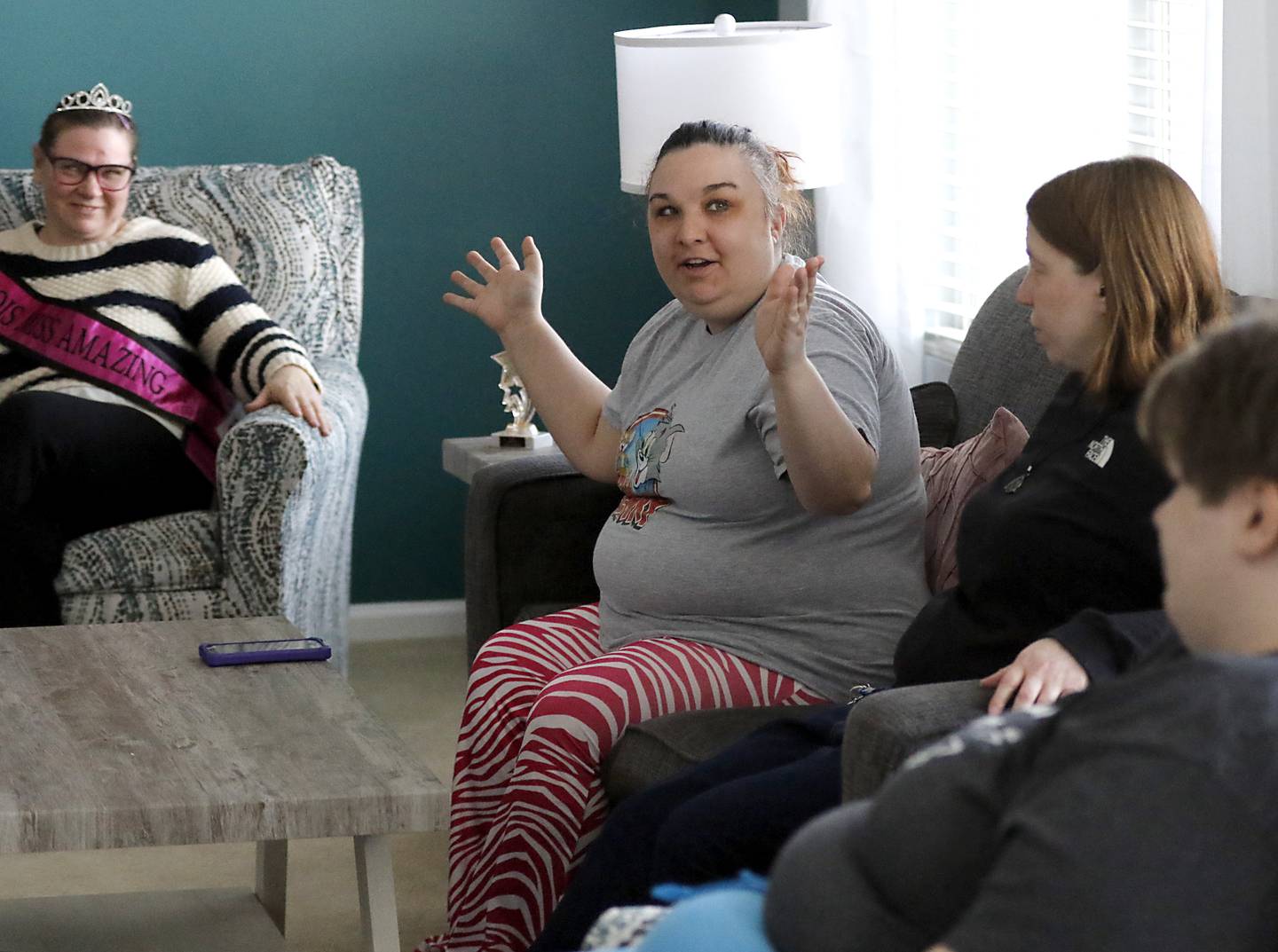 Kris Klemme, Brittany Woods , Jackie Medina, and Sammi Huffman talk in their home on Tuesday, March 13, 2025. The home is Clearbrook's new community integrated living arrangement home for adults with developmental disabilities in Woodstock.