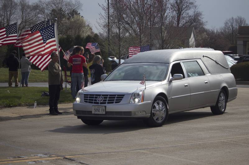 A hearse carrying the body of U.S. Army Staff Sgt. Jose Dueñez Jr. on Friday, April 18, 2025, outside Tezak Funeral Home in Joliet. A funeral procession was held for Dueñez, one of four soldiers who died March 31, 2025 when their armored vehicle sunk in a bog during a training mission in Lithuania.