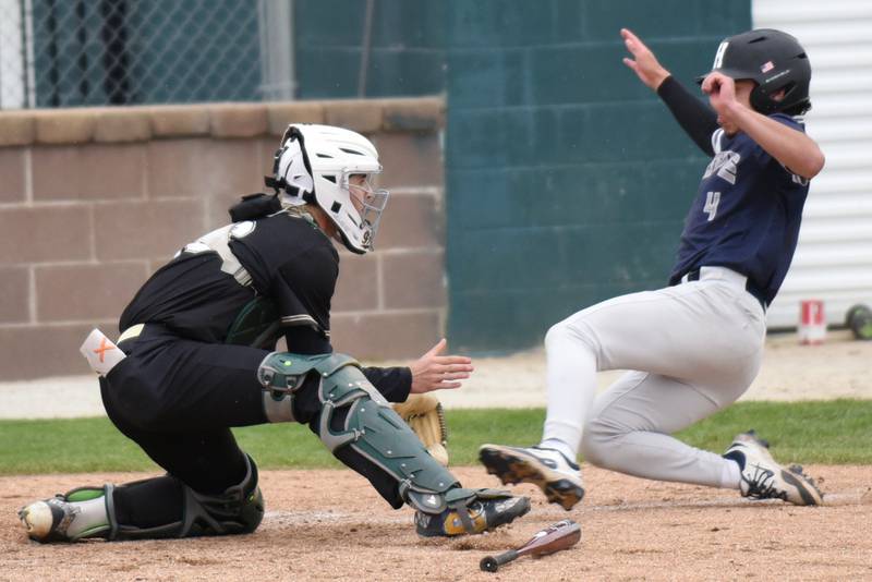 Bishop McNamara's Brayon Ricketts, left, fields a throw at home plate before tagging out Hope Academy's Julian Serrano during a game at Bishop McNamara Thursday, April 30, 2026.
