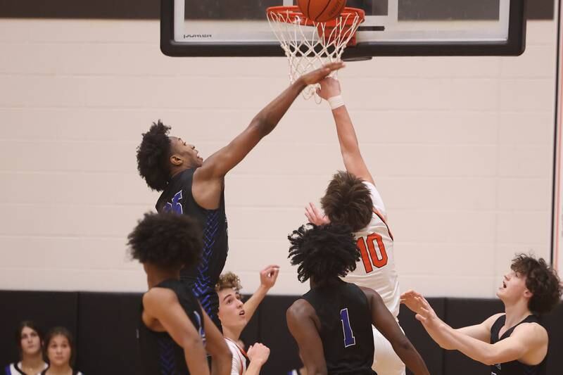 Lincoln-Way East’s George Bellevue blocks a shot against Lincoln-Way West.