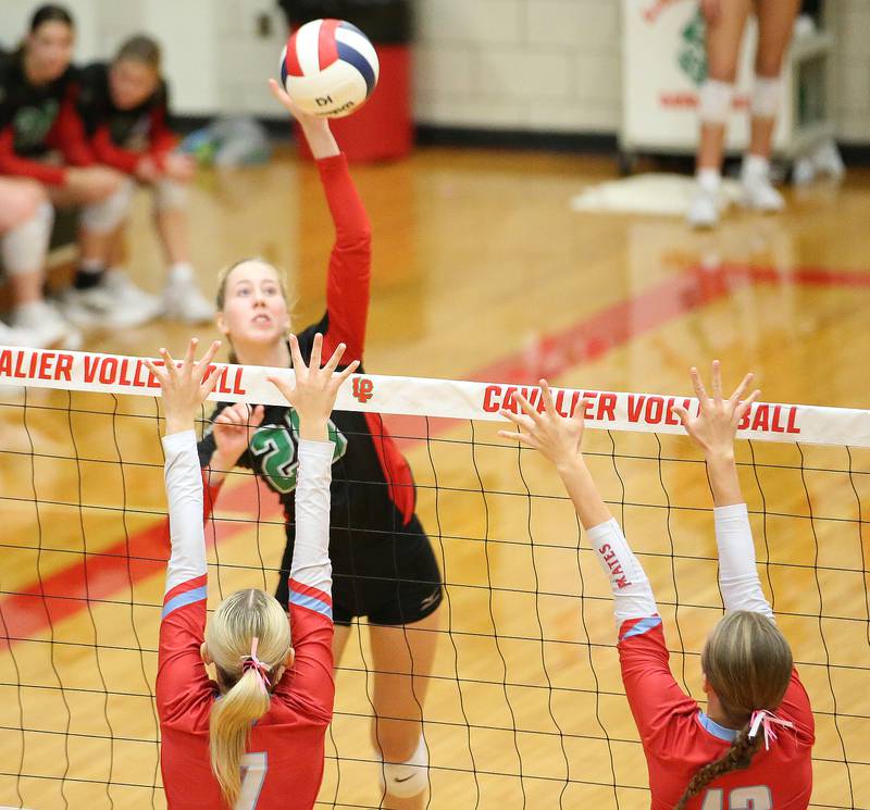 L-P's Addison Urbanski sends a spike past Ottawa's Ryleigh Stevenson and teammate Ayla Dorsey on Tuesday, Oct. 17, 2023 at Sellett Gymnasium.