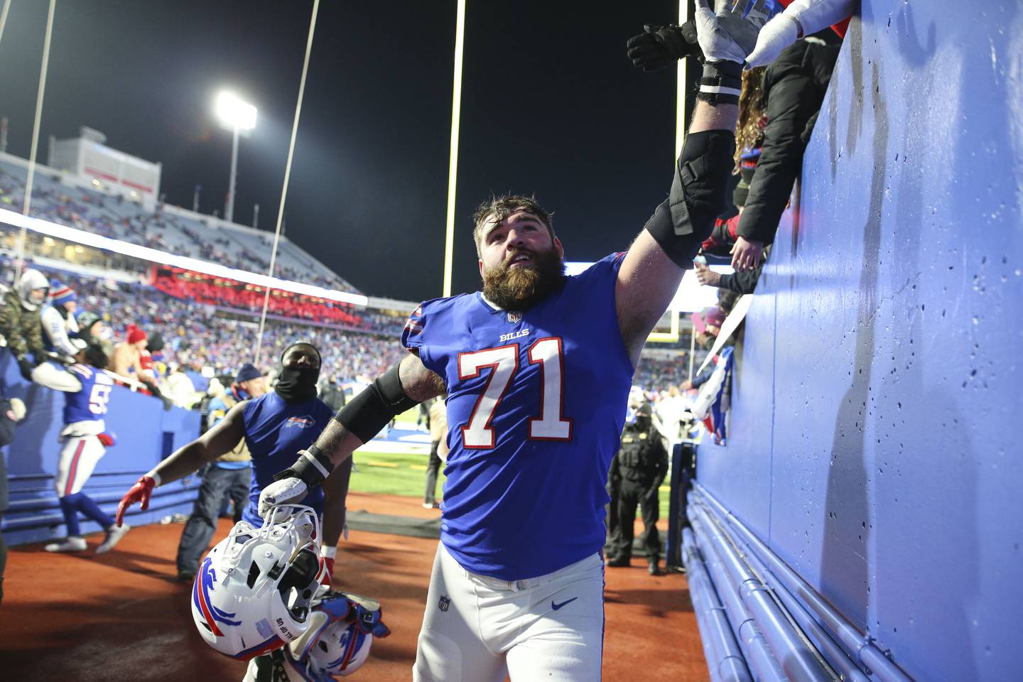 Buffalo Bills' Ryan Bates celebrates with fans after an NFL football game against the New York Jets, Sunday, Jan. 9, 2022, in Orchard Park, N.Y. The Bills defeated the Jets 27-10.