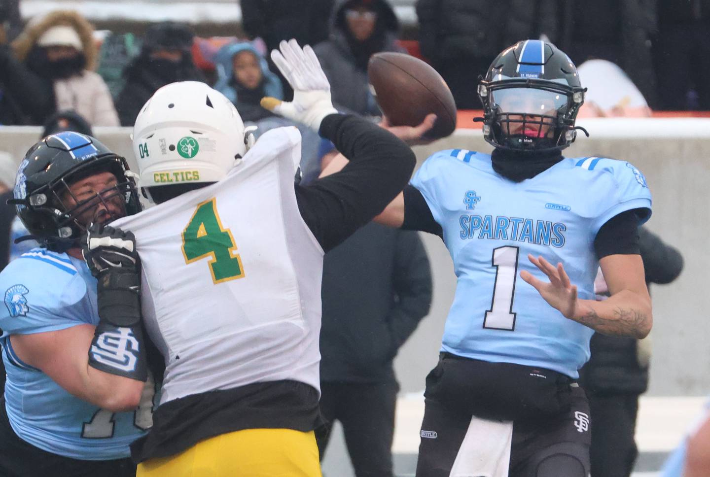 St. Francis quarterback Brock Phillip throws a pass as Providence Catholic's Lamar Winfield tries to get in his face during the Class 5A State championship on Tuesday, Dec. 2, 2025 in Hancock Stadium at Illinois State University in Normal.