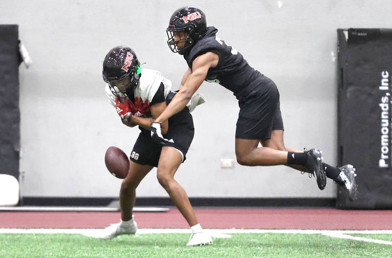 Northern Illinois cornerback Andre Cobb breaks up a pass intended for receiver Malik Armstrong during the teams first spring practice Wednesday, March 22, 2023, in the Chessick Practice Center at Northern Illinois University in DeKalb.
