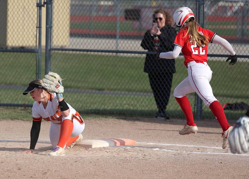 DeKalb's Kennedy Latimer stretches to force out Naperville Central's Avery Hayward Wednesday, April 16, 2025, during their game at DeKalb High School.