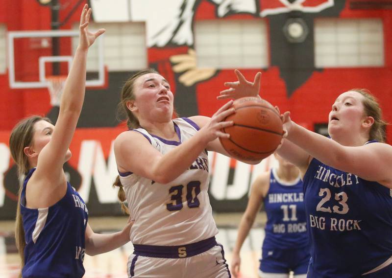 Serena's Maddie Glade grabs a rebound between Hinckley-Big Rock defenders Payton Murphy and teammate Sami Carlino during the Little Ten Conference championship game on Friday, Jan. 24, 2025 at Earlville High School.