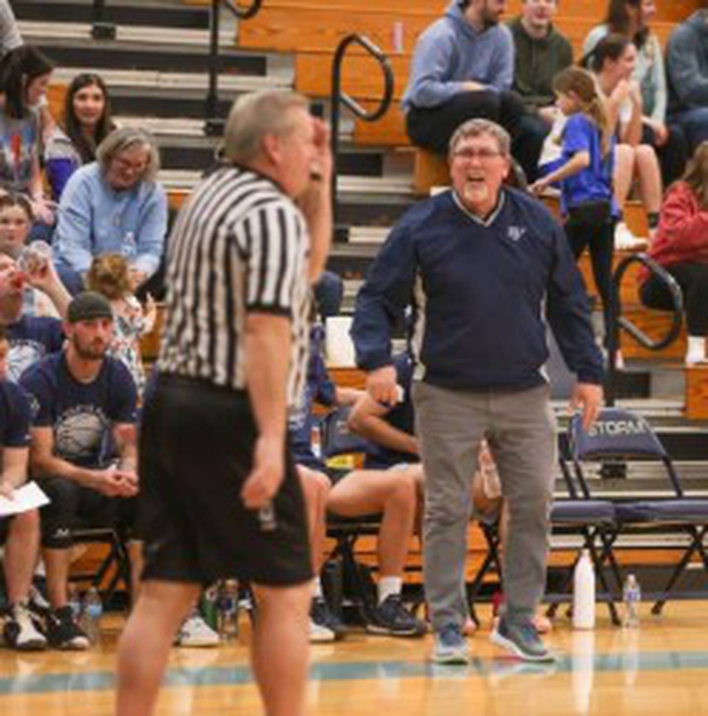 Retired Bureau Valley coach Brad Bickett gives Dave Shepard some officiating help during Sunday's Alumni Game at the Storm Cellar.