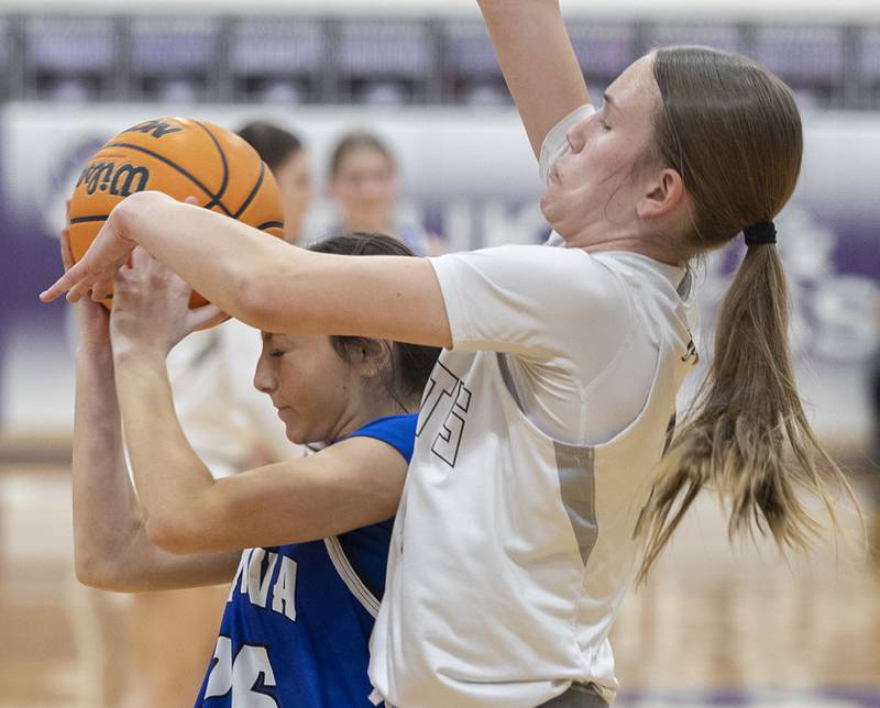 Genava’s Kendall Persons (left) and Kaneland’s Grace Brunscheen battle for the ball Monday, Feb. 16, 2026, in the Class 3A regional semifinals.