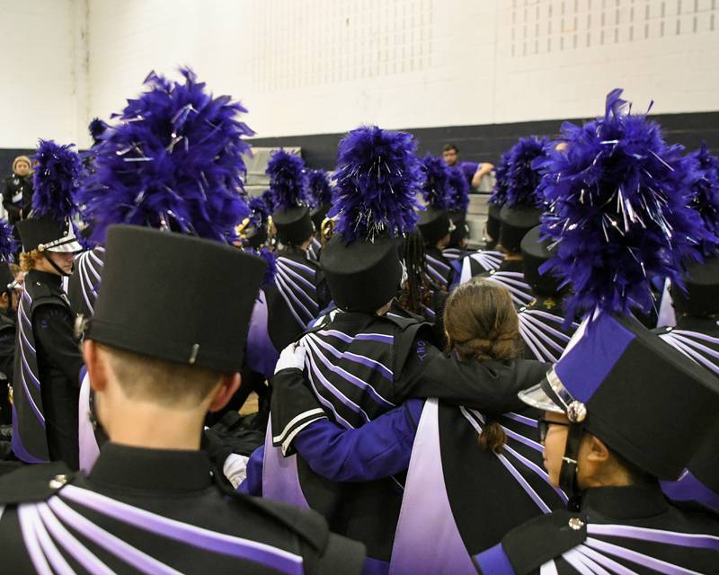Downers Grove North band members listen to Downers Grove North band director Jessen T. Smith as he talks to the band before they take the field at the Downers Grove South Marching Mustangs Music Bowl on Saturday Oct. 5, 2024, held at Downers Groves South football field.