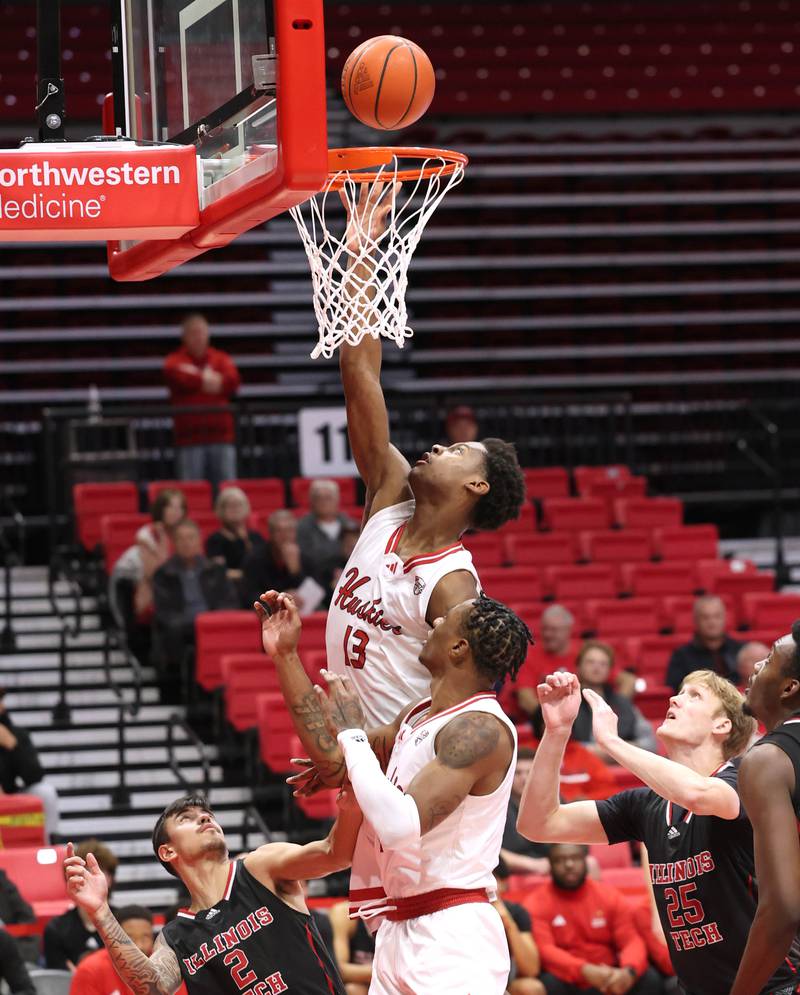 Northern Illinois' Xavier Amos scores over Illinois Tech's Caden Gigstad during their game Monday, Nov. 13, 2023, at the NIU Convocation Center in DeKalb.