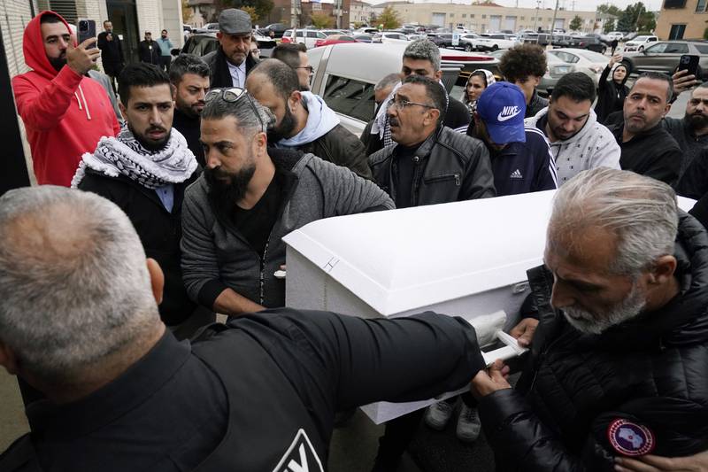 Family members of Wadea Al Fayoume bring his casket into Mosque Foundation in Bridgeview, Ill., Monday, Oct. 16, 2023.