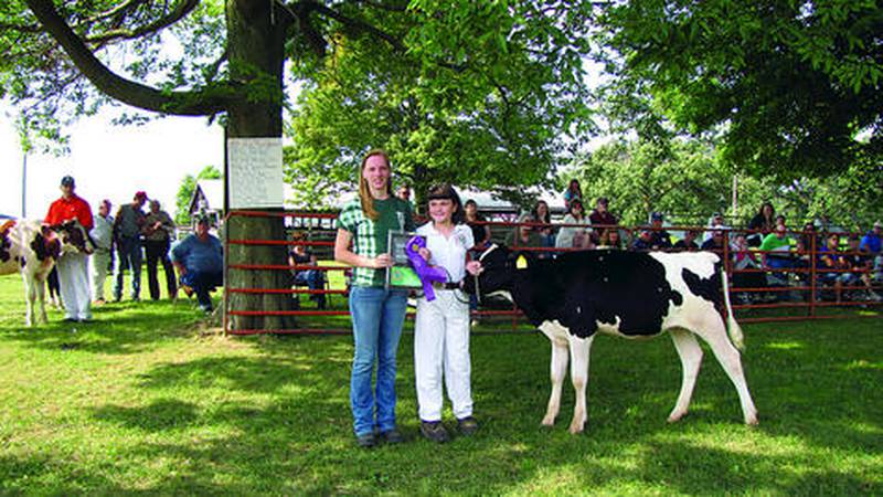 Dena Harridge (left) presented Lakin Getz of Savanna with the champion dairy bucket calf award during the Carroll County 4-H Fair in Milledgeville. The fair took place from Aug. 3 to Aug. 10 at the fairgrounds. Photos submitted by Susan O'Connor.