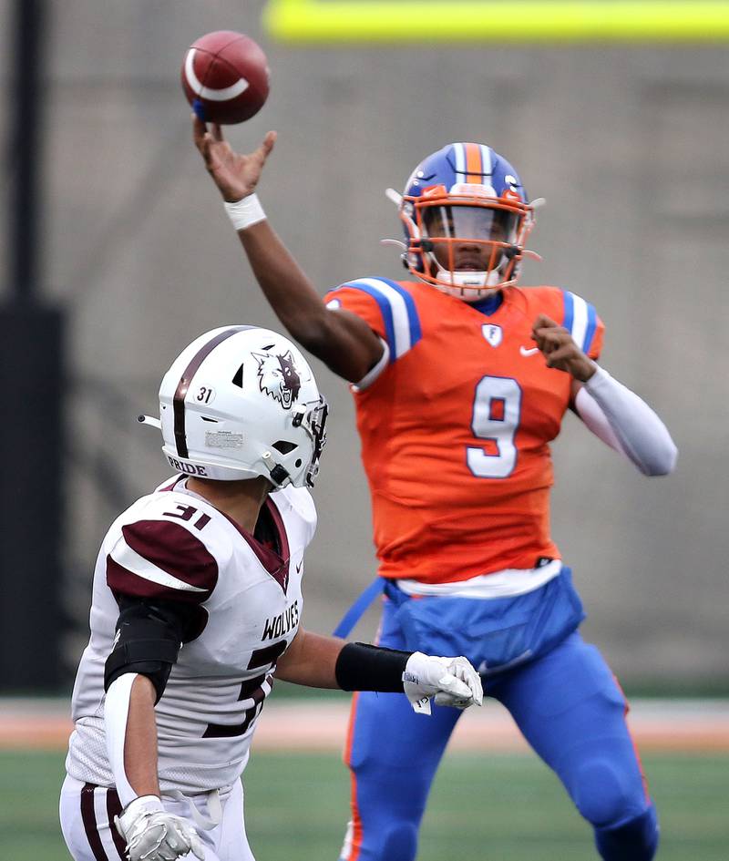 East St. Louis' Robert "Pops" Battle throws a pass over Prairie Ridge's Landon Severson during their IHSA Class 6A state championship game Saturday, Nov. 26, 2022, in Memorial Stadium at the University of Illinois in Champaign.